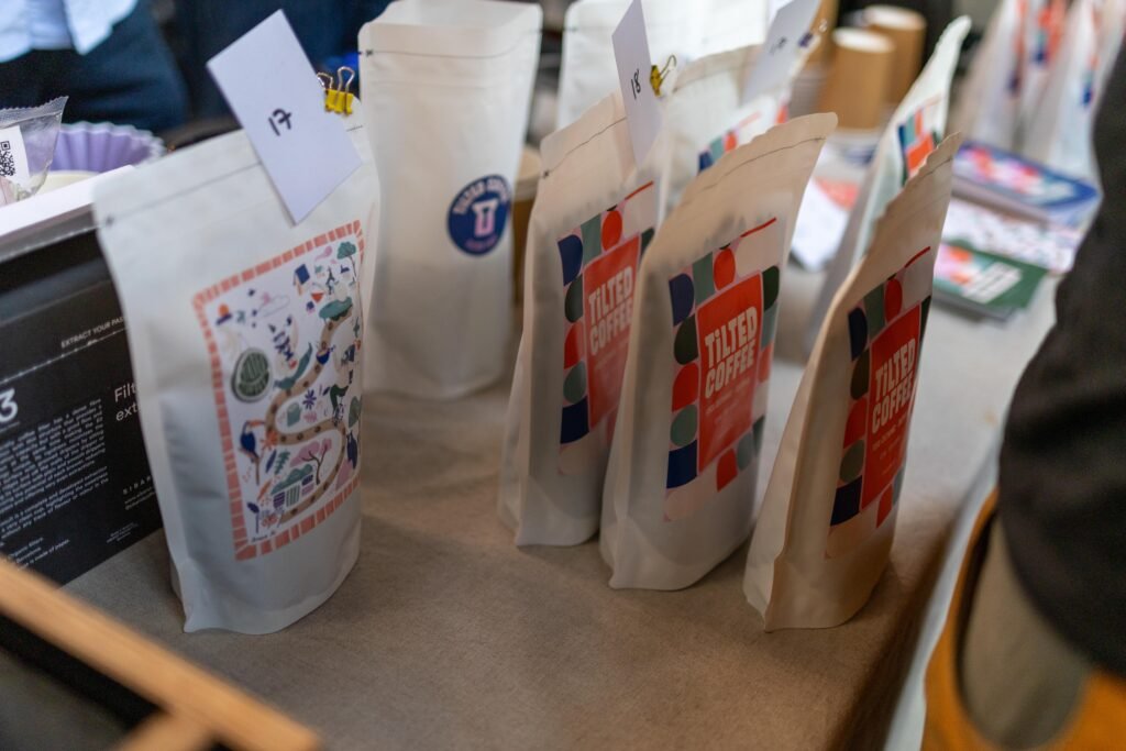 Tilted Coffee bags with colourful illustrated labels on the table